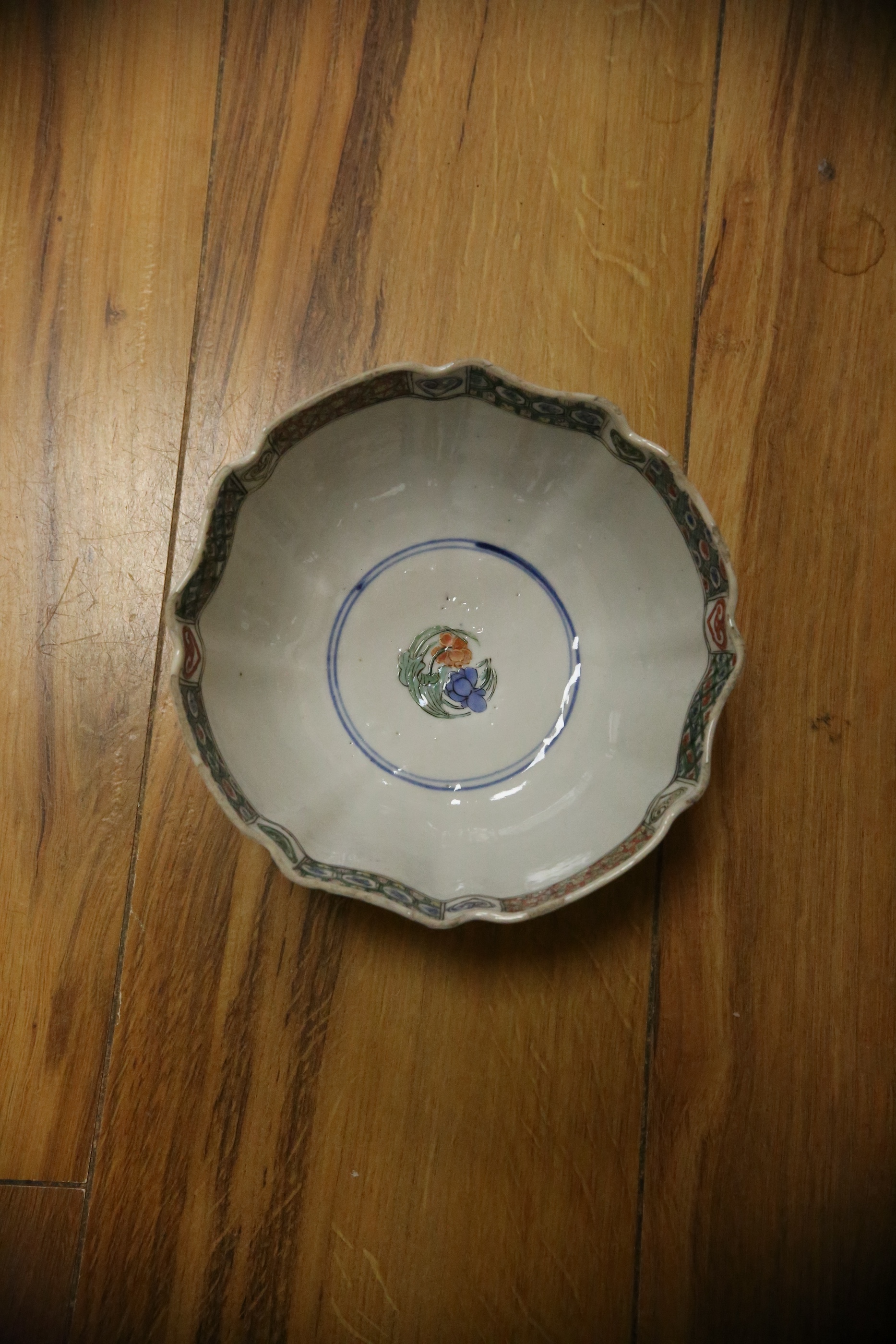 A Chinese famille verte powder blue ground bowl and a similar dish, both Kangxi period, 27.5cm diameter. Condition - dish poor, bowl fair